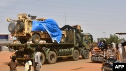 FILE - A military truck of the Nigeiren security forces, part of an escort to a French Army military convoy crosses the Lazaret district in Niamey on October 10, 2023.