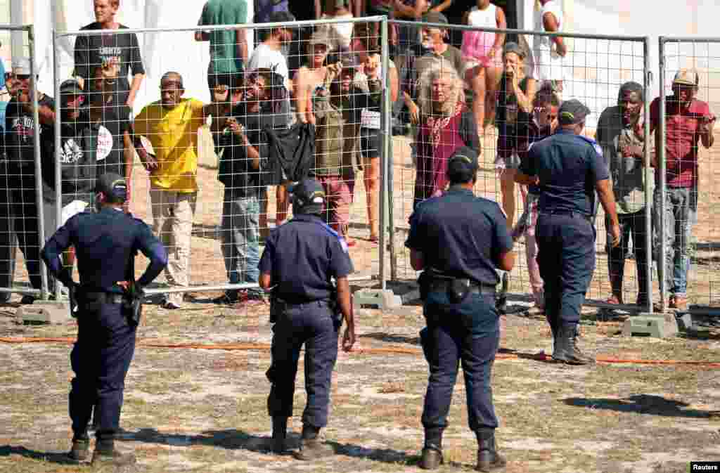 Tensions flare as homeless people attempt to speak to journalists at a camp set up by disaster management authorities during the 21-day nationwide lockdown aimed at limiting the spread of coronavirus disease (COVID-19) in Cape Town, South Africa.