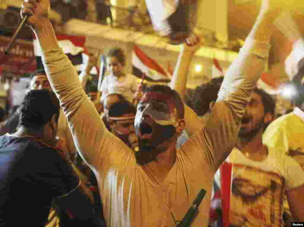 Anti-Morsi protesters chant as they celebrate into the night after the announcement of his removal from office, Tahrir Square in Cairo, July 3, 2013. 