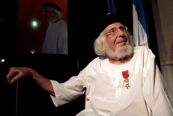 FILE - Nicaraguan poet and Catholic priest Ernesto Cardenal sits after he was awarded the Legion of Honor order during a reception in Managua, Nicaragua, Sept. 30, 2013.