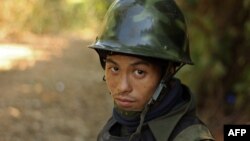 A rebel Kachin Independence Army (KIA) 3rd Brigade soldier stands guard as they secure an area on Hka Ya mountain in Kachin province on January 20, 2013.