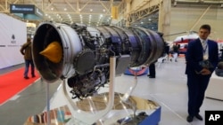 FILE - A visitor looks at a turbofan AI-322F engine for combat trainers and light combat aircraft made by Ukraine's Motor Sich manufacturer at an international weapons exhibition in Kyiv, Ukraine, Oct. 9, 2018. 
