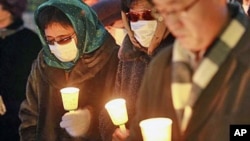 FILE - Former North Korean defectors pay silent tribute during a rally for victims of human rights abuses in Seoul, South Korea, in December 2010.