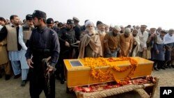 Petugas keamanan Pakistan siaga penuh saat pemakaman korban serangan di Universitas Bacha Khan di Charsadda, Pakistan (21/1). 