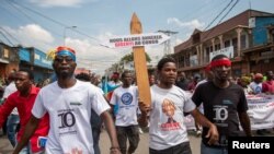 Civilians participate in a protest in support of the FARDC in Goma