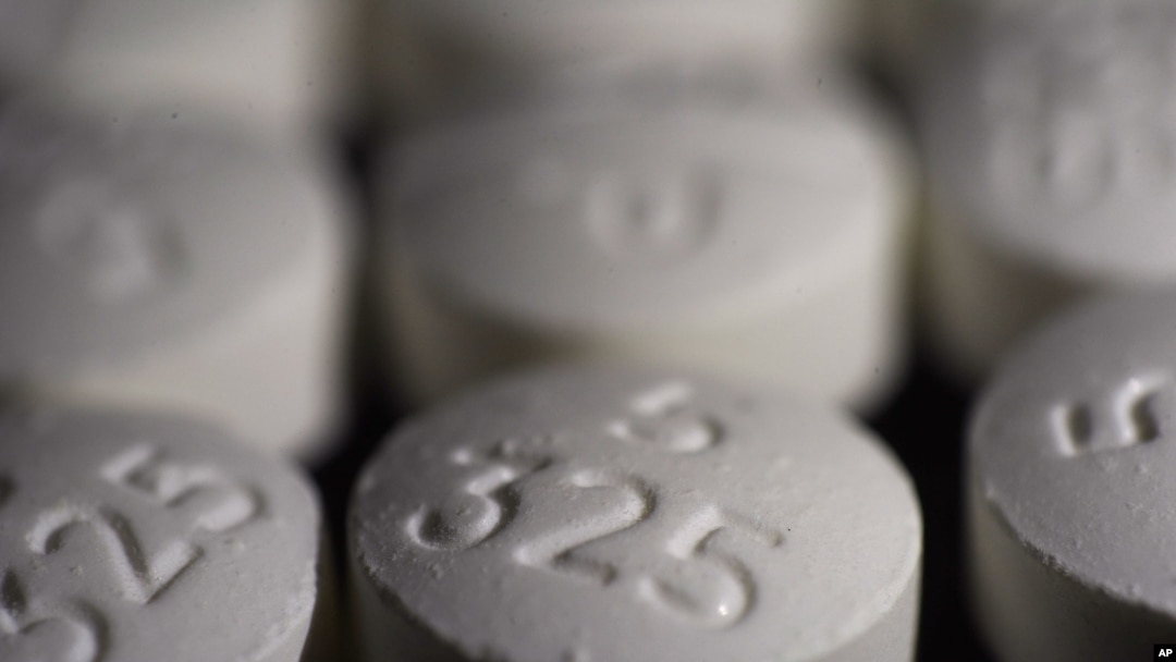 FILE - This Aug. 15, 2017, photo shows an arrangement of pills of the opioid oxycodone-acetaminophen, in New York.