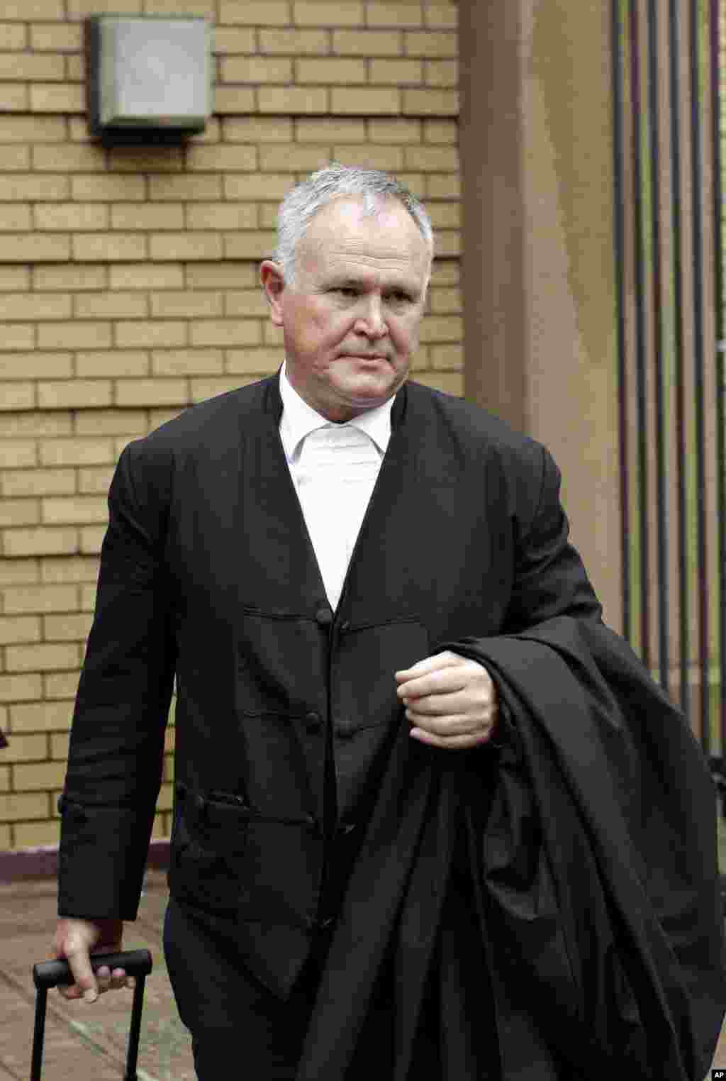 Oscar Pistorius&#39;s lawyer, Barry Roux, arrives at the high court in Pretoria. The State Prosecutor Gerrie Nel presented arguments in the case against Pistorius, who was acquitted of murder for killing girlfriend Reeva Steenkamp, South Africa, Dec. 9, 2014. &nbsp;
