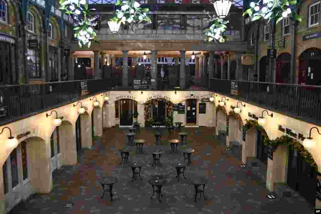 Empty tables of a bar and restaurant in the Covent Garden area of central London, Thursday, Nov. 5, 2020. Britain joined large swathes of Europe in a coronavirus lockdown designed to save its health care system from being overwhelmed. Pubs, along with res