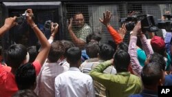 An Indian man convicted for the 2002 Gujarat riots is taken back to jail after the court announced the lengths of the sentences in Ahmadabad, India on June 17, 2016.