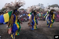 Gule Wamkulu dance secretive society members in masks and colorful outfits perform their ritual dance in Harare, Zimbabwe on October 23, 2022.(AP Photo/Tsvangirayi Mukwazhi)