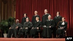 In this photo taken Oct. 8, 2012, the justices of the U.S. Supreme Court gather for a group portrait at the Supreme Court Building in Washington. The Supreme Court will begin hearing arguments on Monday morning, March 26, 2012, over President Barack Obama