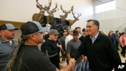 Mitt Romney shaking hands during a campaign stop at the Sportsmen for Fish and Wildlife Banquet, in Blanding, Utah, March 2, 2018.