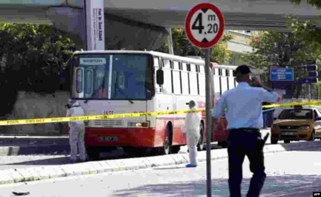 Police forensic officers inspect a blast scene in Istanbul May 26, 2011. A bomb placed on an electric bicycle exploded in Istanbul on Thursday, wounding seven people, Istanbul's police chief Huseyin Capkin told reporters. He said none of the wounded were 