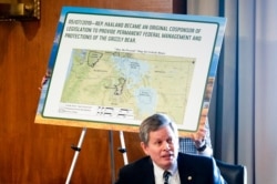 A board is put up as Sen. Steve Daines, R-Mont., speaks during the Senate Committee on Energy and Natural Resources hearing on Capitol Hill in Washington, Feb. 23, 2021.