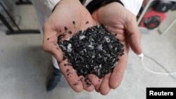 Christofer Costes, a French inventor who created a machine that turns plastic waste into fuel, displays pieces of plastic in Puget-Theniers, France, Dec. 14, 2018. 