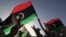 Libyans celebrate on the streets in Tripoli's Martyrs' Square after casting their vote during the National Assembly election, July 7, 2012. 