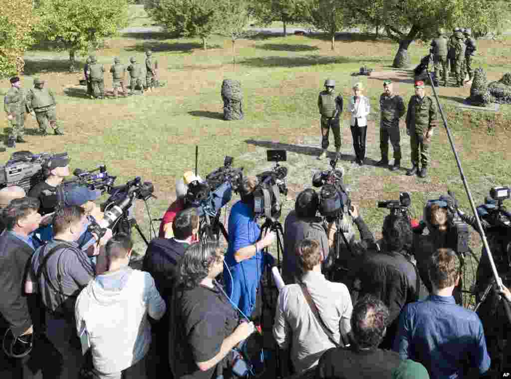 German Defense Minister Ursula von der Leyen talks with journalists during the training of Kurdish peshmerga fighters with anti-tank guns at the Infantry School of the German Federal Armed Forces Bundeswehr in Hammelburg, Germany, Oct. 2, 2014.