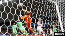 Alman Andre Schuerrle make yon gòl kont gadyen aljeryen an, Rais Mbolhi, nan peryòd pwolongasyon match ant 2 ekip yo(Foto 30 jen, 2014).