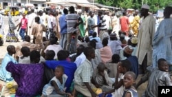 Civilians who fled their homes following an attacked by Islamist militants in Bama, take refuge at a School in Maiduguri, Nigeria, Wednesday, Sept. 3, 2014. A Nigerian senator says thousands of people are fleeing a northeastern city amid conflicting reports that it has been seized by Boko Haram Islamic militants. Sen. Ali Ndume said Tuesday the military is claiming it has repelled the insurgents in fierce fighting for the city of Bama but the stream of refugees indicates otherwise. (AP Photo/Jossy Ola)