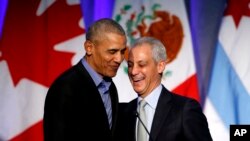 Former U.S. President Barack Obama, left, shares a laugh with Chicago Mayor Rahm Emanuel after Emanuel introduced Obama at a summit on climate change involving mayors from around the globe, Dec. 5, 2017, in Chicago.
