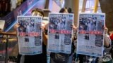 People hold up copies of the Apple Daily as they protest for press freedom 