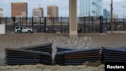 FILE - A U.S. Customs and Border Protection (CBP) vehicle is driven along a fence in El Paso, Texas, U.S., in this picture taken from Ciudad Juarez, Mexico, Feb. 14, 2019.