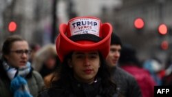 A spporter of US President-elect Donald Trump waits outside for a MAGA victory rally at Capital One Arena in Washington, DC, on January 19, 2025, one day ahead of Trump's inauguration. (Photo by ANGELA WEISS / AFP)