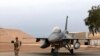 FILE - in this Tuesday, Feb. 13, 2018 file photo, an Iraqi army soldier stand guard near a U.S.- made Iraqi Air Force F-16 fighter jet at the Balad Air Base, Iraq. 