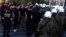 Riot police try to stop members of the Golden Dawn party from unloading food from a vehicle in Athens, Greece, May 2, 2013.