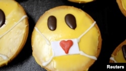 Cakes that look like emojis with protective masks are seen at the bakery Schuerener Backparadies as the spread of COVID-19 continues in Dortmund, Germany, April 9, 2020.