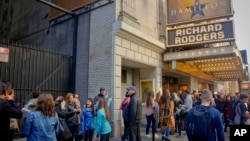 People line up to see the musical "Hamilton," Nov. 19, 2016, in New York. A man was arrested at the play in Chicago Saturday after shouting election-related comments, a misdemeanor.