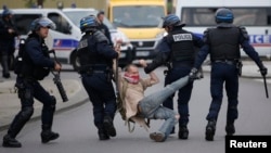 French police apprehend a man during a demonstration to protest the government's proposed labour law reforms in Nantes, France, May 26, 2016.