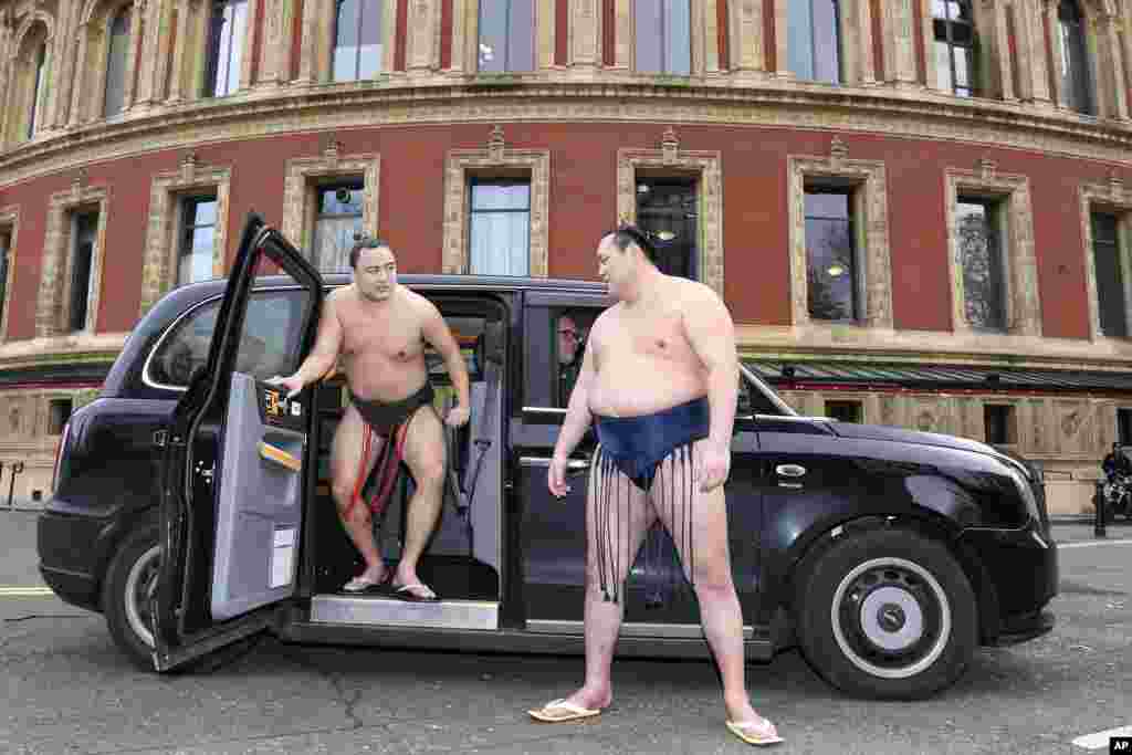 Rishikis from Japan&#39;s Sumo Kyokai, Daisuke Kitanowaka, right, and Akira Fukutsuumi pose for a photo call outside of London&#39;s Royal Albert Hall in London where the UK&#39;s second ever official basho will take place in October of next year.