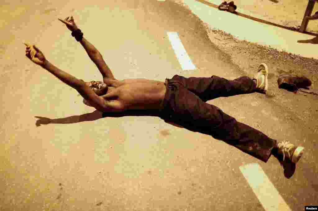 An African migrant reacts as he arrives at the CETI, the short-stay immigrant center, after crossing the border from Morocco to Spain&#39;s North African enclave of Ceuta, Spain.