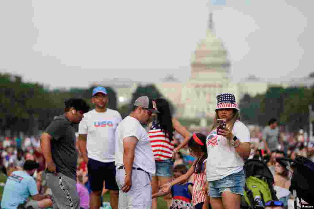 People gather for the Independence Day fireworks display at the National Mall in Washington, July 4, 2021. 