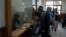 Petugas Taliban memeriksa paspor di Islam Qala, perbatasan Afghanistan-Iran, 24 November 2021. (AP Photo/Petros Giannakouris)