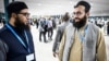 Hamed Safi (R), a member of Afghanistan's delegation, talks to his colleague during a break in a plenary session of the COP29 Summit in Baku on Nov. 11, 2024, on the opening day of the 2024 UN Climate Change Conference. 