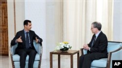 New U.S. ambassador Robert Ford (R) talks with Syria's President Bashar al-Assad after presenting his credentials to Assad, in Damascus January 27, 2011.