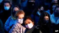 People gather at the bandstand in Clapham Common in memory of Sarah Everard, after an official vigil was canceled, in London, March 13, 2021. Everard went missing while walking home March 3; a police officer is charged with kidnapping and killing her.
