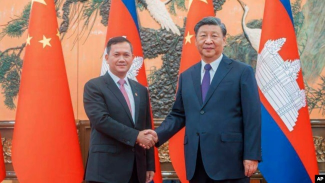 FILE - Cambodian Prime Minister Hun Manet, left, shakes hands with Chinese President Xi Jinping during a ceremony in Beijing on Sept. 15, 2023. (Cambodia's Prime Minister Telegram via AP)