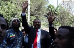 Jawar Mohammed, an Oromo activist and leader of the Oromo protest waves to his supporters outside his house in Addis Ababa, Ethiopia, Oct. 23, 2019.