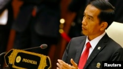FILE - Indonesia's President Joko Widodo, shown at an ASEAN summit meeting last year in Naypyitaw, Myanmar, says he has "not received any information on threats of a security breach." 