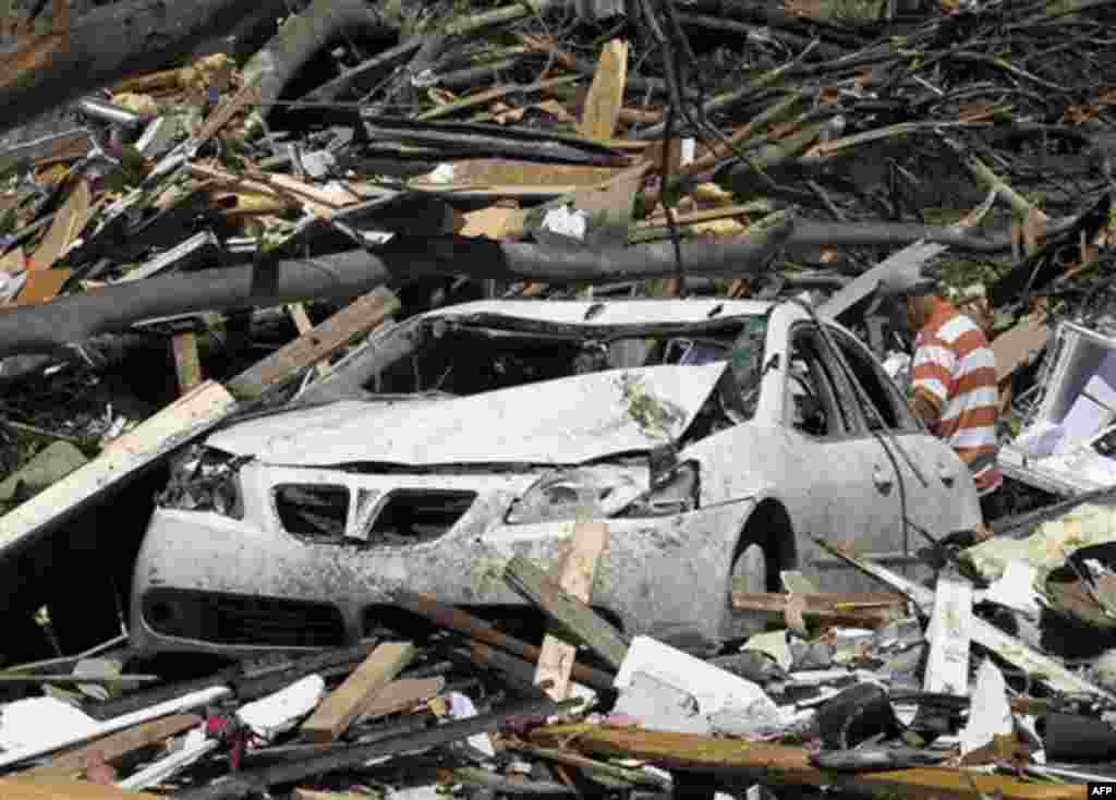 People look for their belongings at an apartment complex in the Alberta City neighborhood Thursday April 28, 2011, after a tornado struck Tuscaloosa, Ala. the day before. Massive tornadoes tore a town-flattening streak across the South, killing at least 2