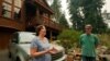 Diane Nelson and her husband, Rick, discuss the approaching Caldor Fire that threatens their home on Fallen Leaf Lake near South Lake Tahoe, Calif., Aug. 24, 2021.