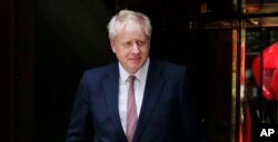 FILE - British Conservative party lawmaker Boris Johnson leaves a TV station after giving an interview in London, June 14, 2019.