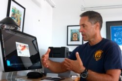 Ecologist Greg Asner, the director of Arizona State University's Center for Global Discovery and Conservation Science, reviews ocean temperature data at his lab on the west coast of the Big Island near Captain Cook, Hawaii, Sept. 13, 2019.