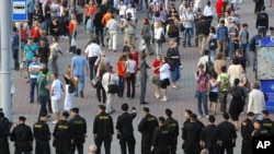 Belarusian policemen block a street during an action "Revolution via social network" in Minsk, Belarus, June 22, 2011.