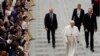 Pope Francis walks in the Paul VI Hall at the end of his weekly general audience at the Vatican, Aug. 21, 2019.