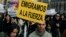 FILE - Demonstrators carry signs reading "We are forced to leave" and "They send us away" during a protest against unemployment among young people and the emigration produced by the financial crisis in Madrid, Spain, April 7, 2013.