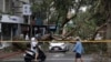 People walk past an area destroyed by the wind from Typhoon Kong-rey in Taipei, Taiwan, Nov. 1, 2024. 